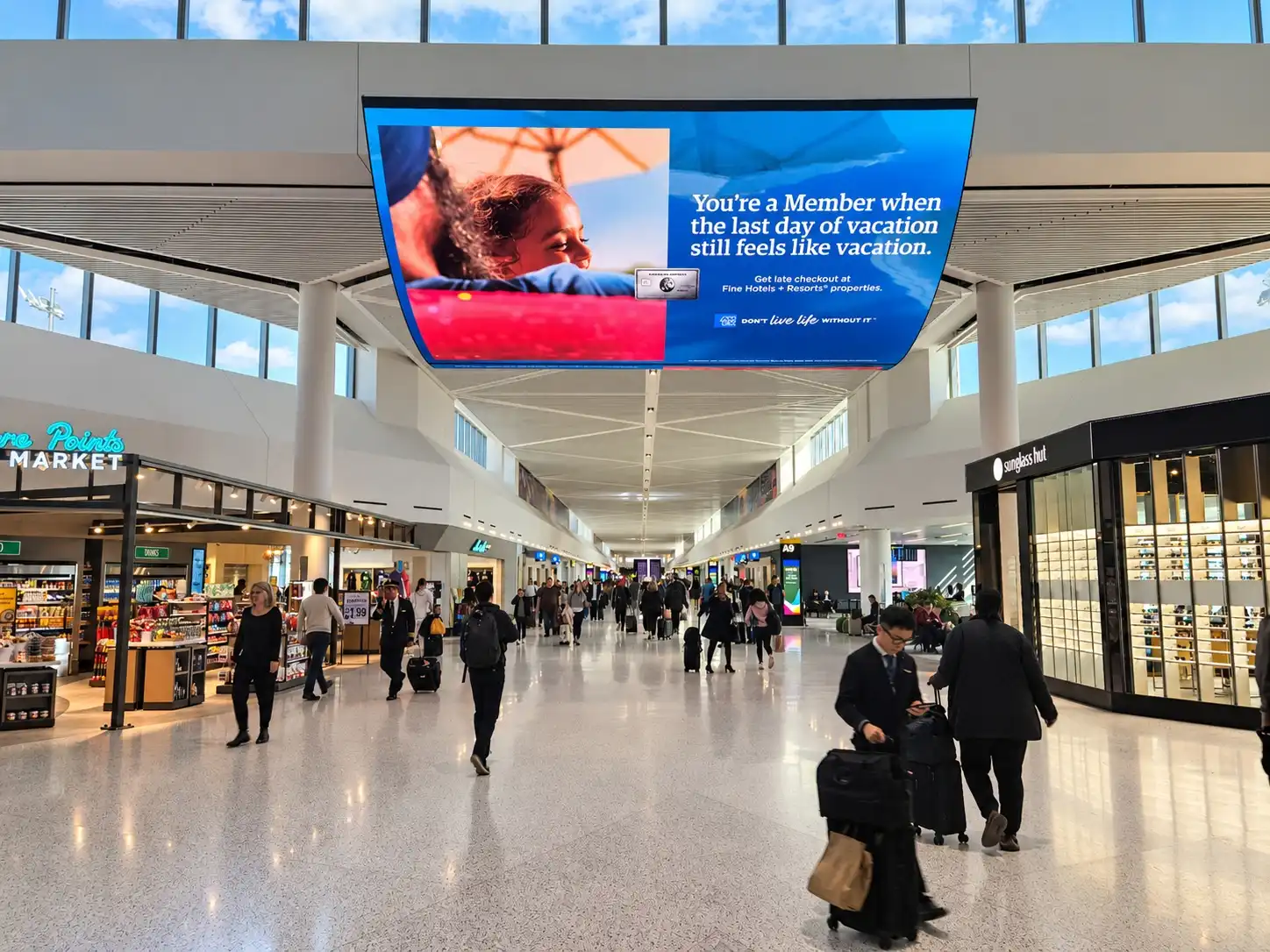 American Express hanging digital spectacular in an airport terminal.